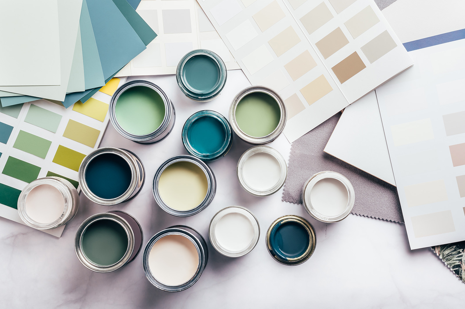 Open paint cans and swatches as seen from above.