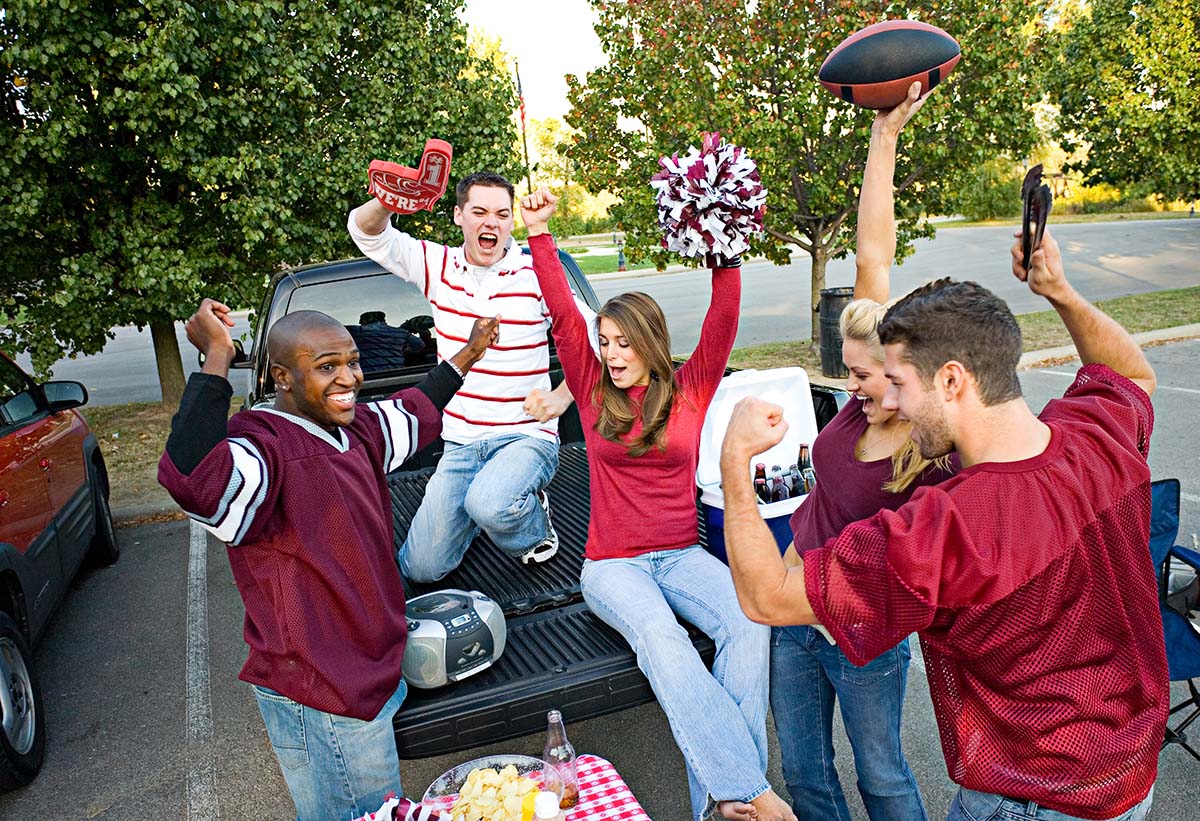 A group of friends tailgating at a football game.